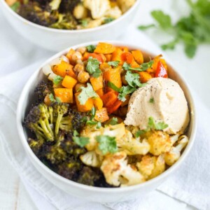 veggie quinoa power bowl with hummus in a white bowl for lunch