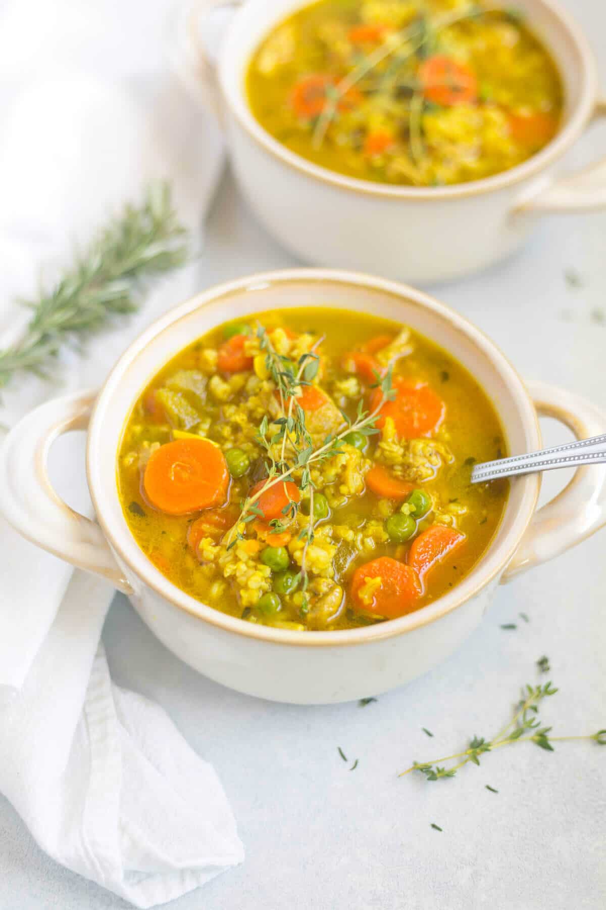 recipe for healthy chicken soup in a white bowl with a spoon on a napkin