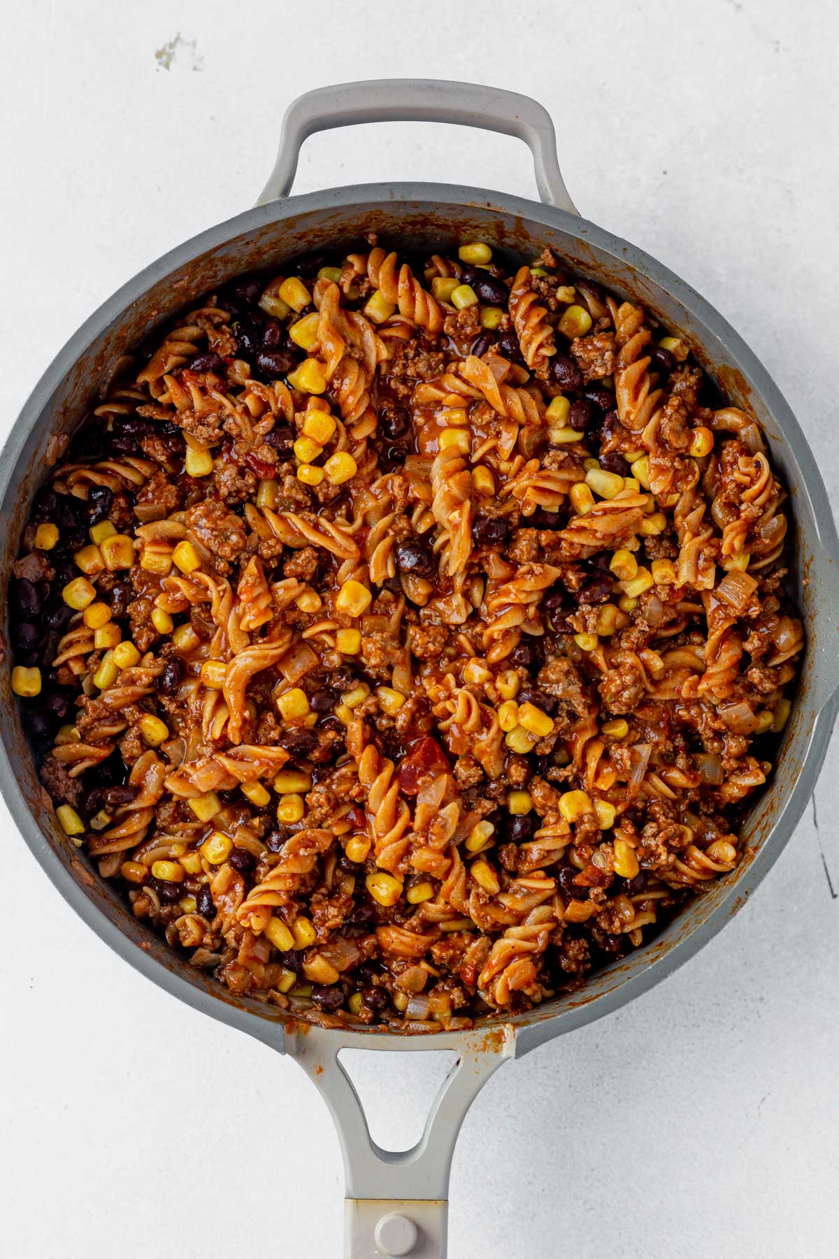 taco pasta recipe in a skillet with corn and beans