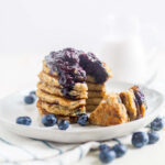 stack of 6 coconut flour pancakes with blueberry topping