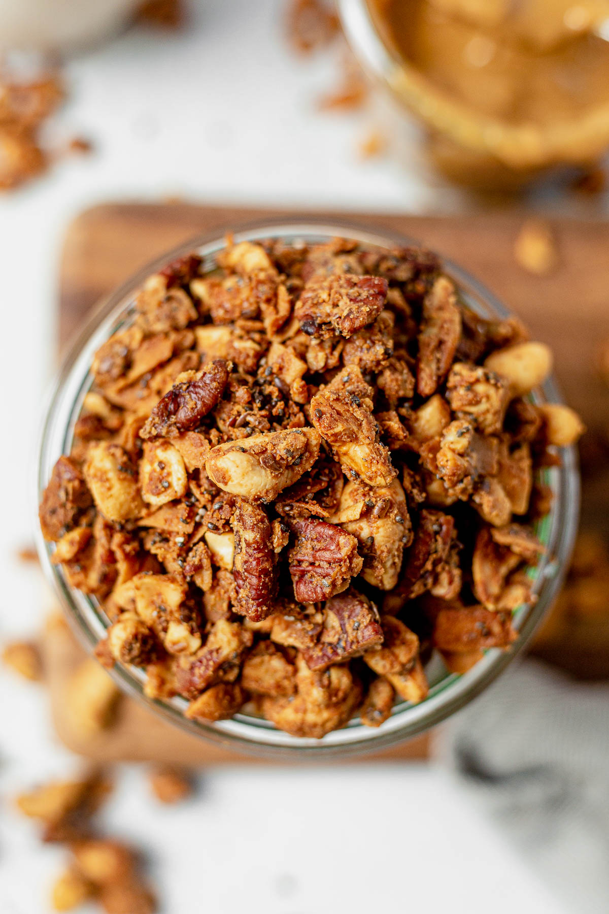 close up of chunky grain free granola in a glass jar