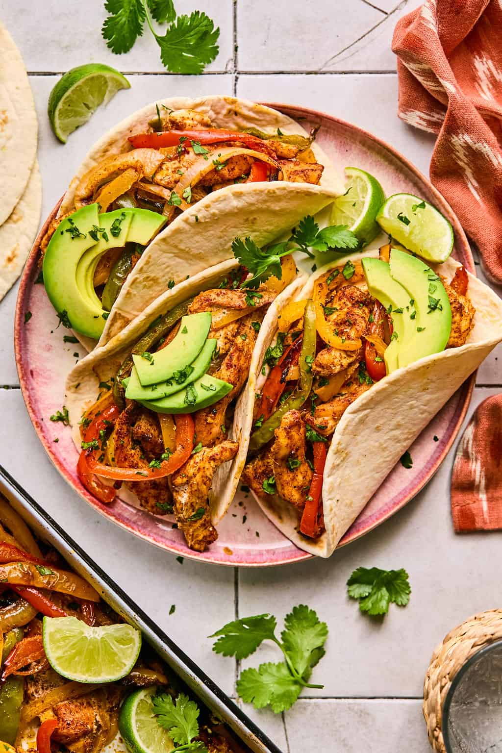 three chicken fajitas on a plate.