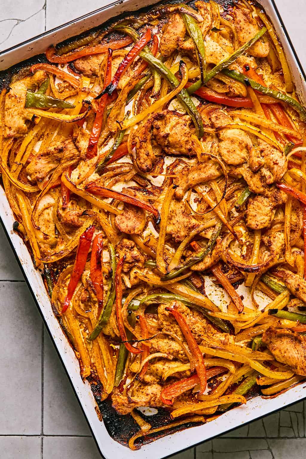 baked chicken fajitas on a sheet pan.