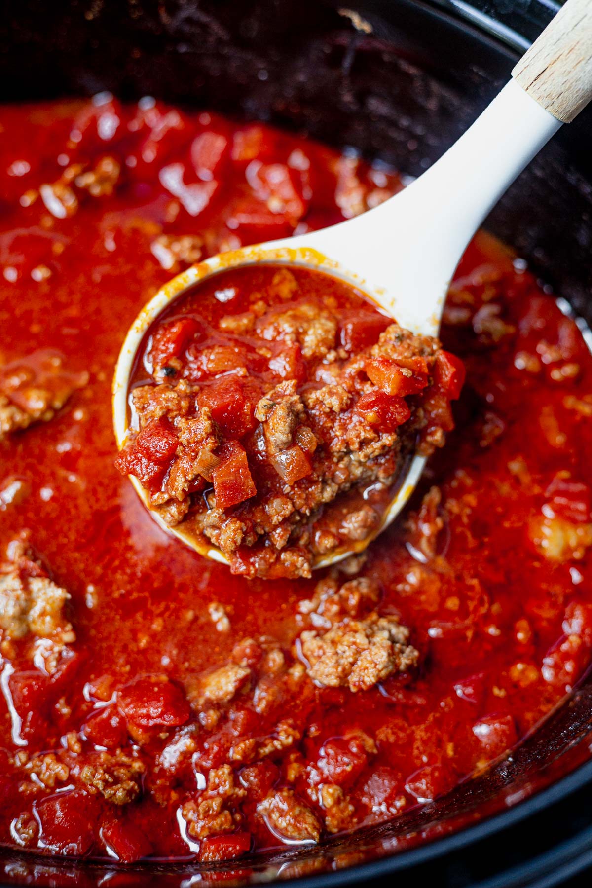 ladle scooping beanless chili out of the crockpot