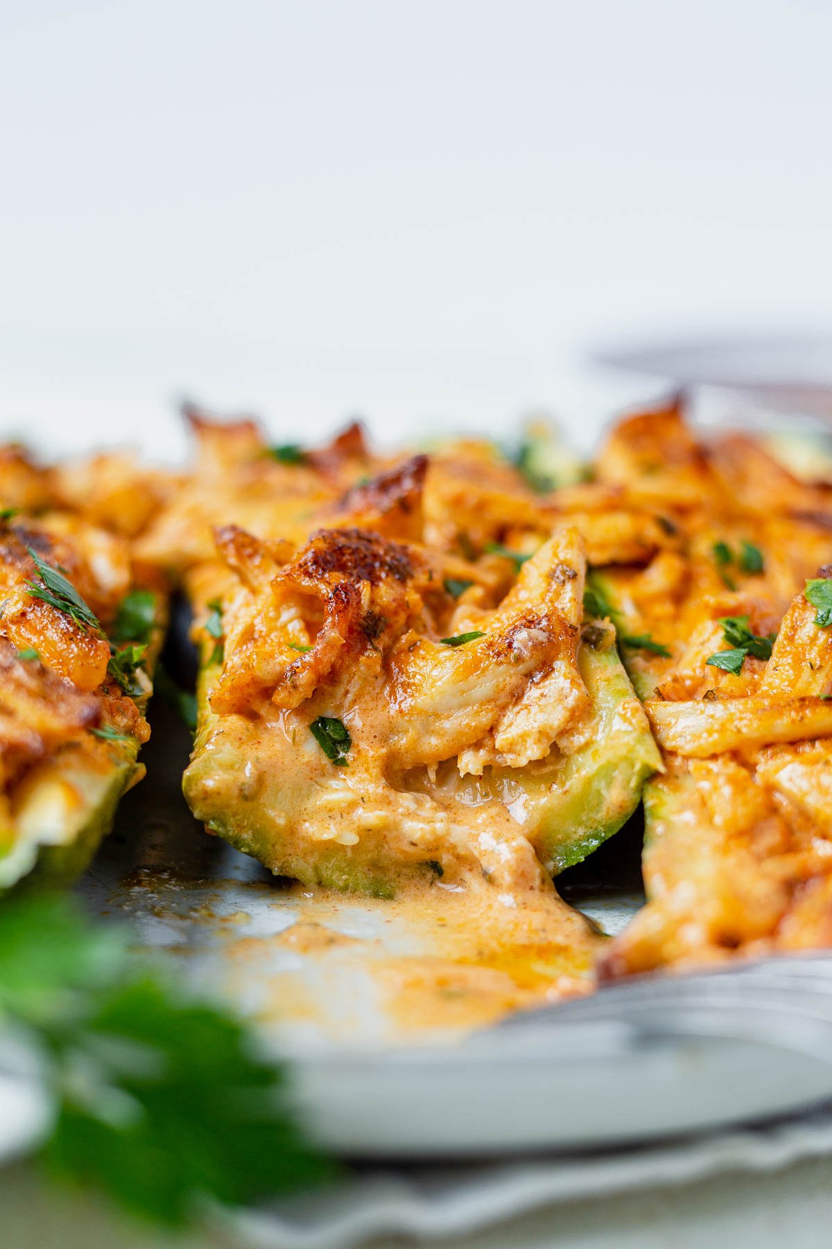 buffalo chicken zucchini boat cut in half