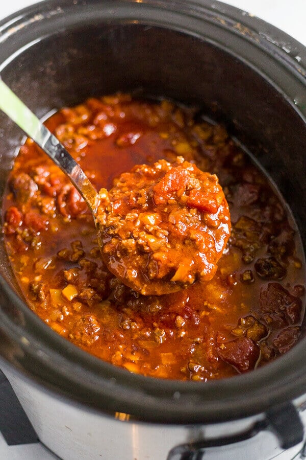 paleo chili in a crock pot with a ladel