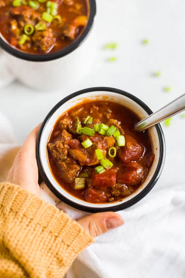 paleo chili crock pot in a mug with a spoon