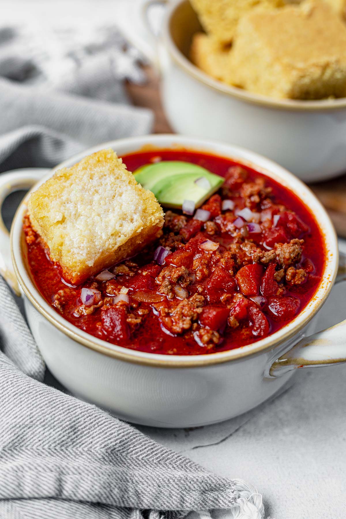 a big bowl of beanless chili with a slice of cornbread on top