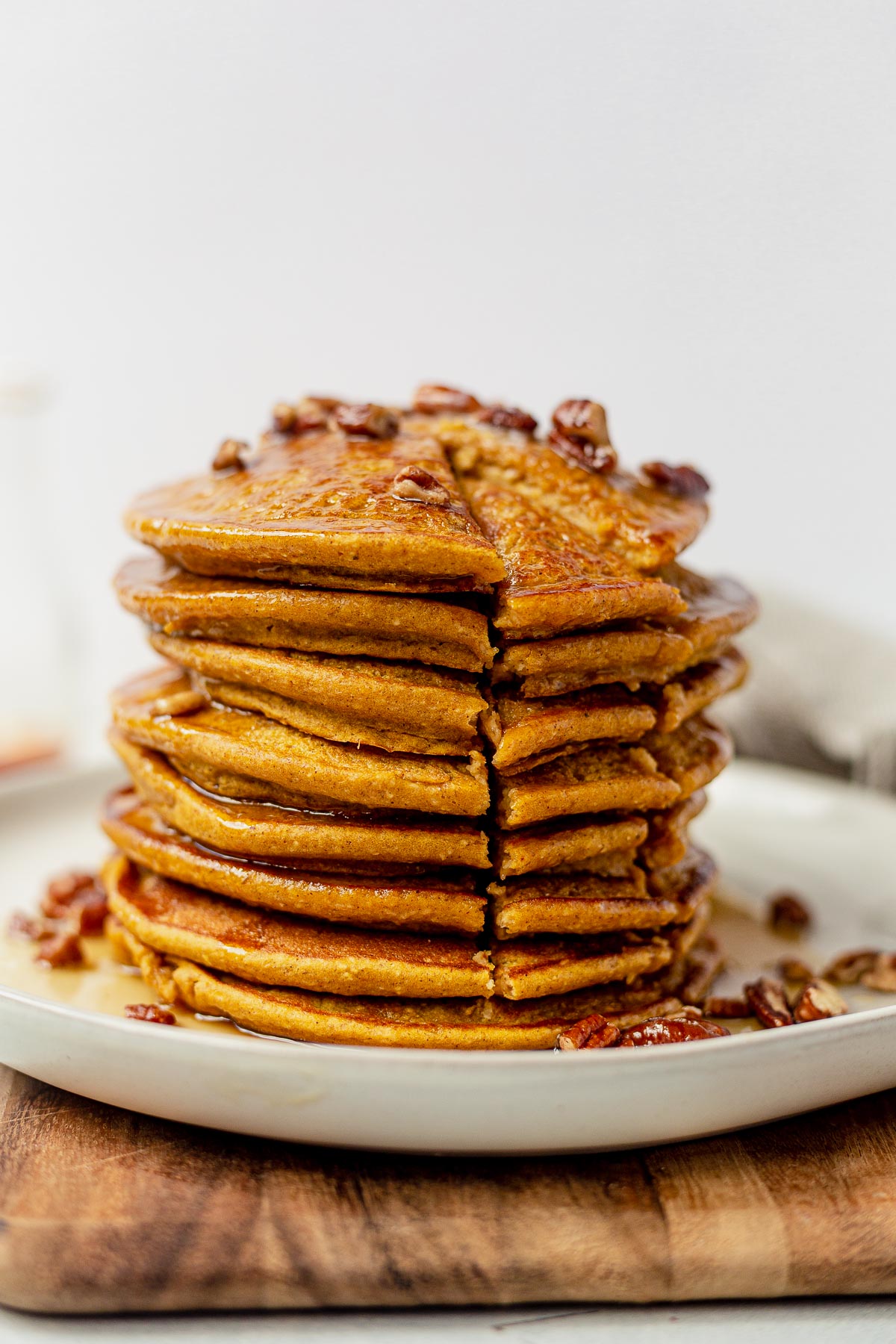 a bite taken out of a stack of healthy pumpkin pancakes