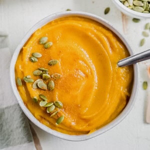 Roasted butternut squash soup in a bowl with pumpkin seeds