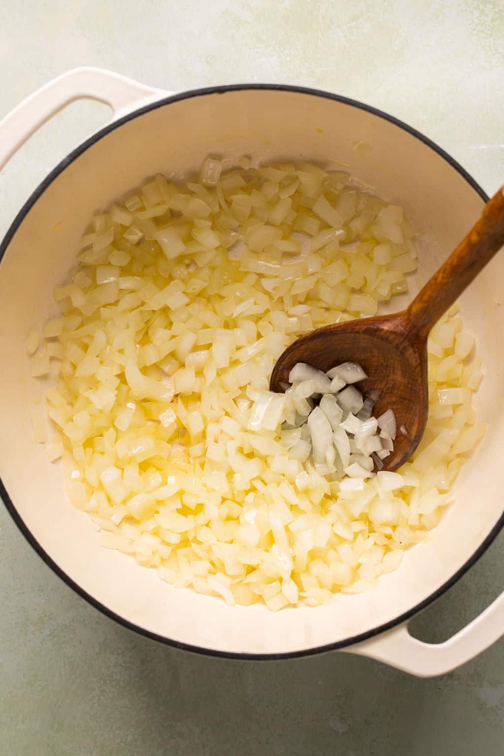 sauteeing onions in a soup pot.