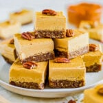 seven pieces of vegan pumpkin cheesecake arranged on a white plate