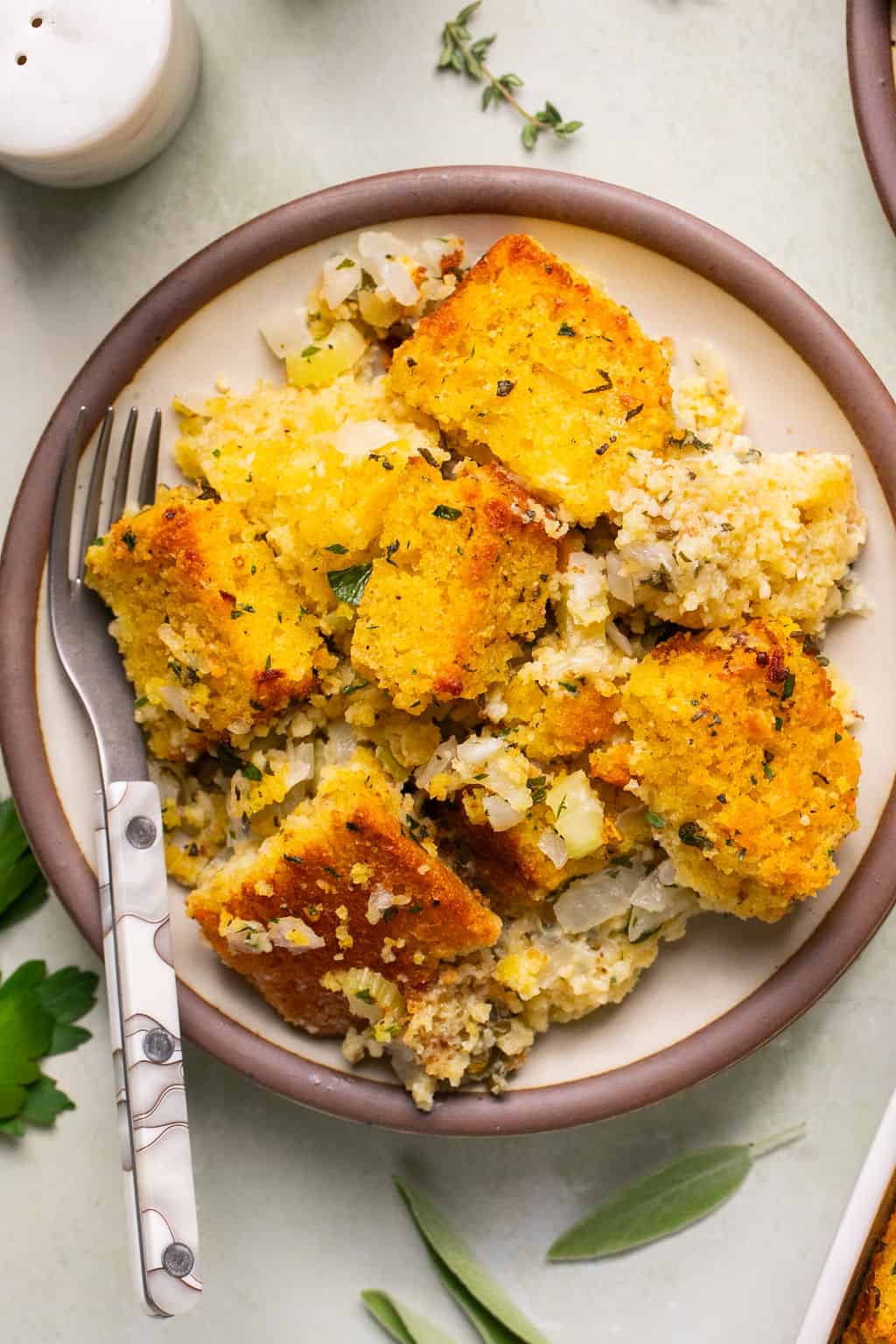 a serving of gluten free cornbread stuffing on a plate with a fork.