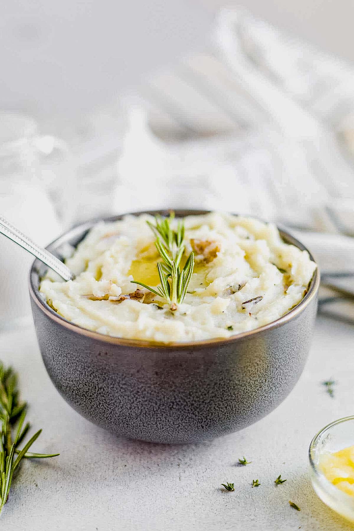 dairy free mashed potatoes in a gray bowl with a spoon