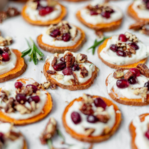 baked sweet potato bites topped with goat cheese, pomegranates, pecans and honey