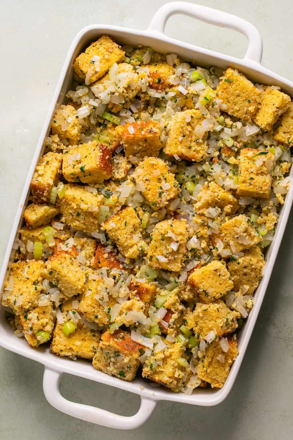 unbaked gluten free cornbread stuffing in a casserole dish.