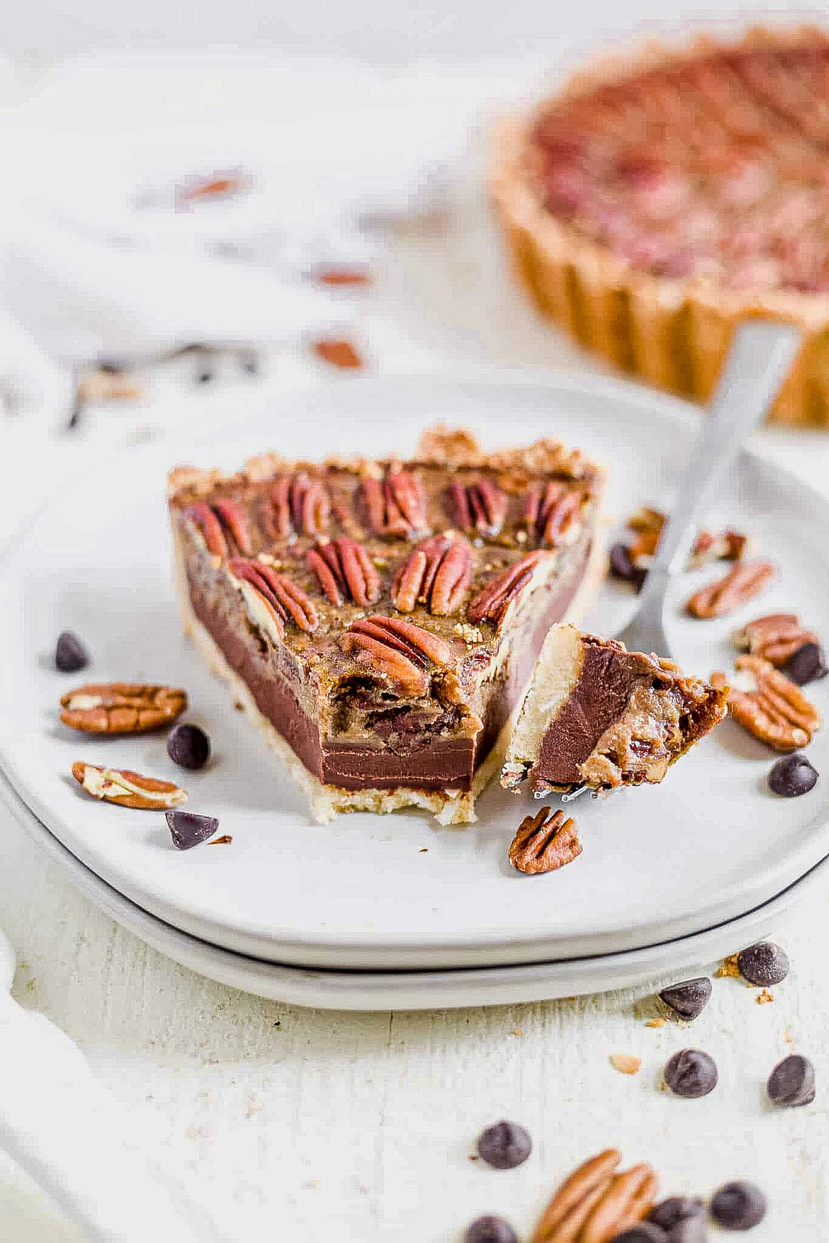 a slice of paleo pecan pie with a bite on a fork