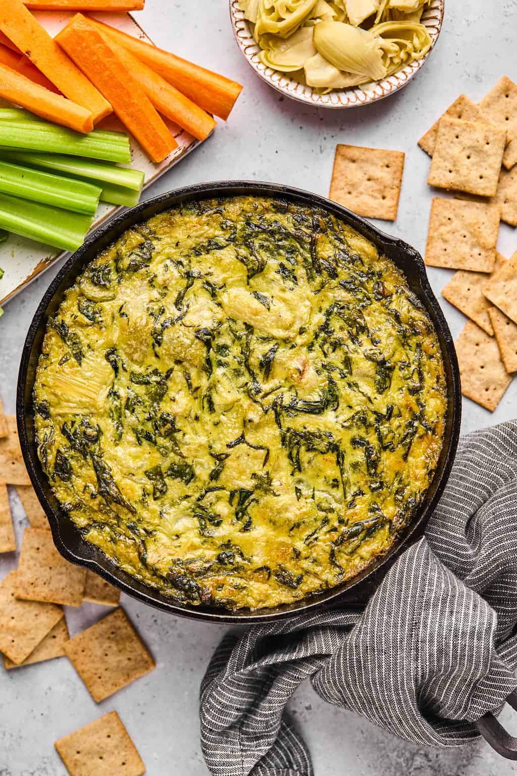 vegan spinach artichoke dip in a cast iron skillet.