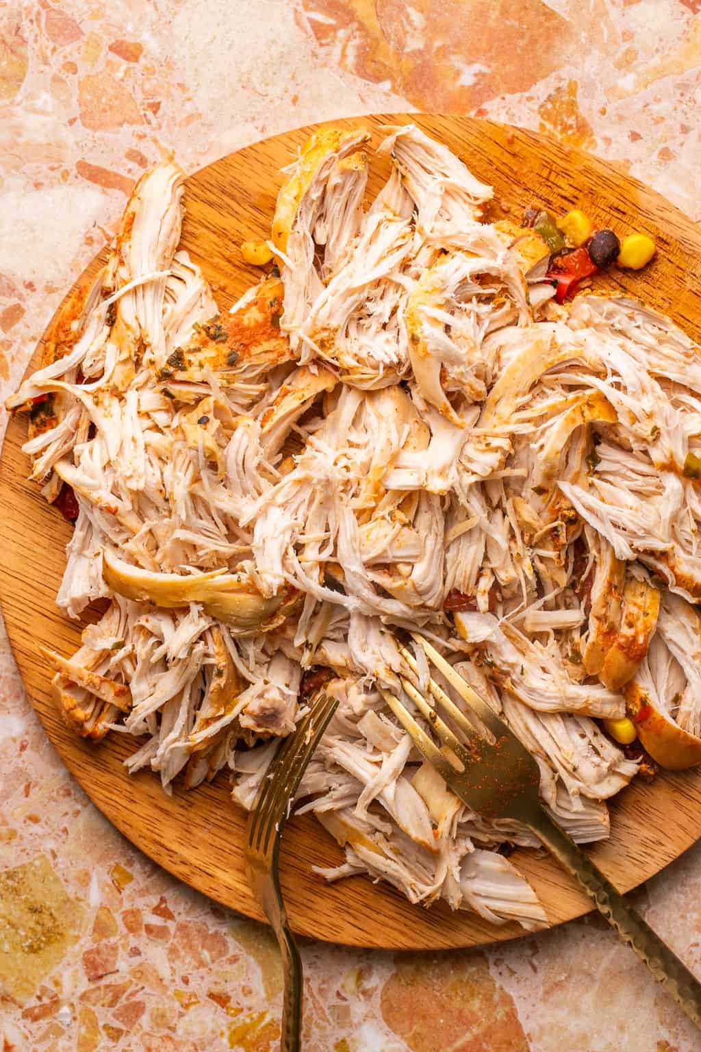 shredded chicken on a cutting board.