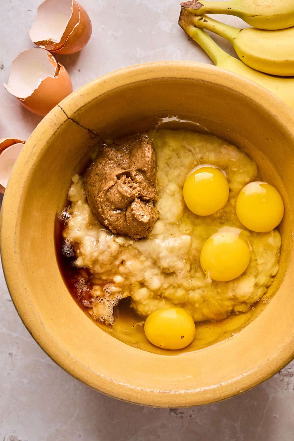 almond butter, eggs, mashed banana, vanilla, and coconut oil in a mixing bowl.