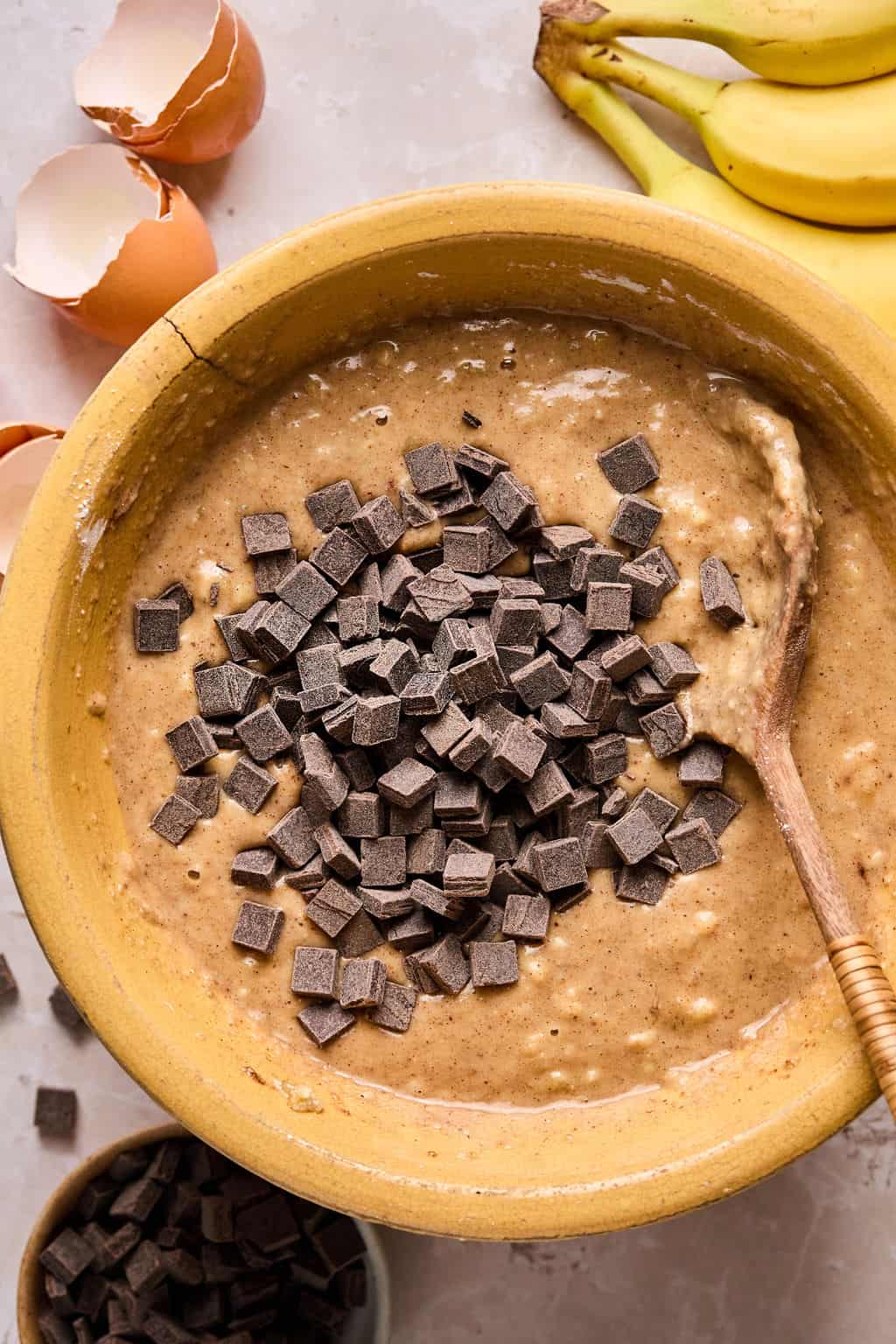 chocolate chips mixing into paleo banana bread batter.