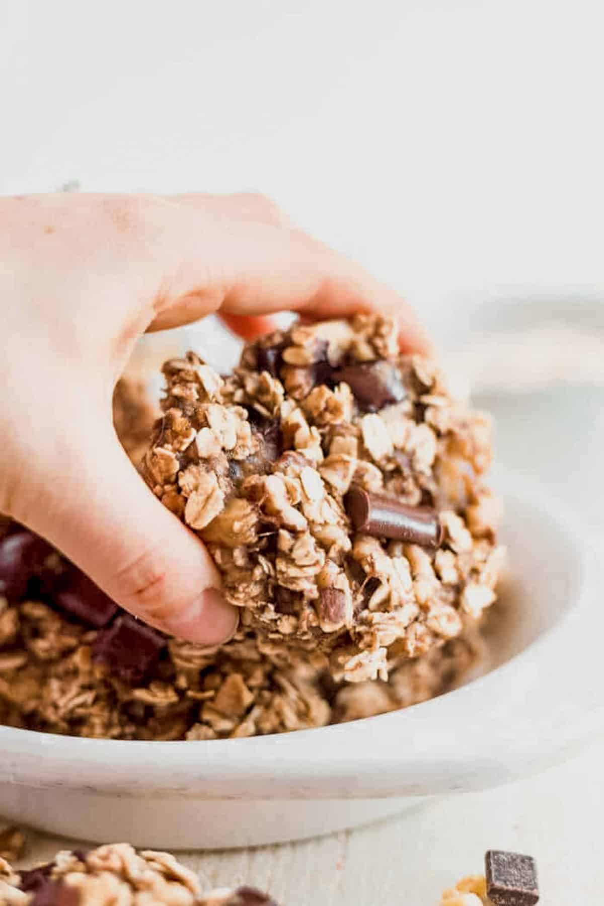 picking an oatmeal banana cookie off a plate