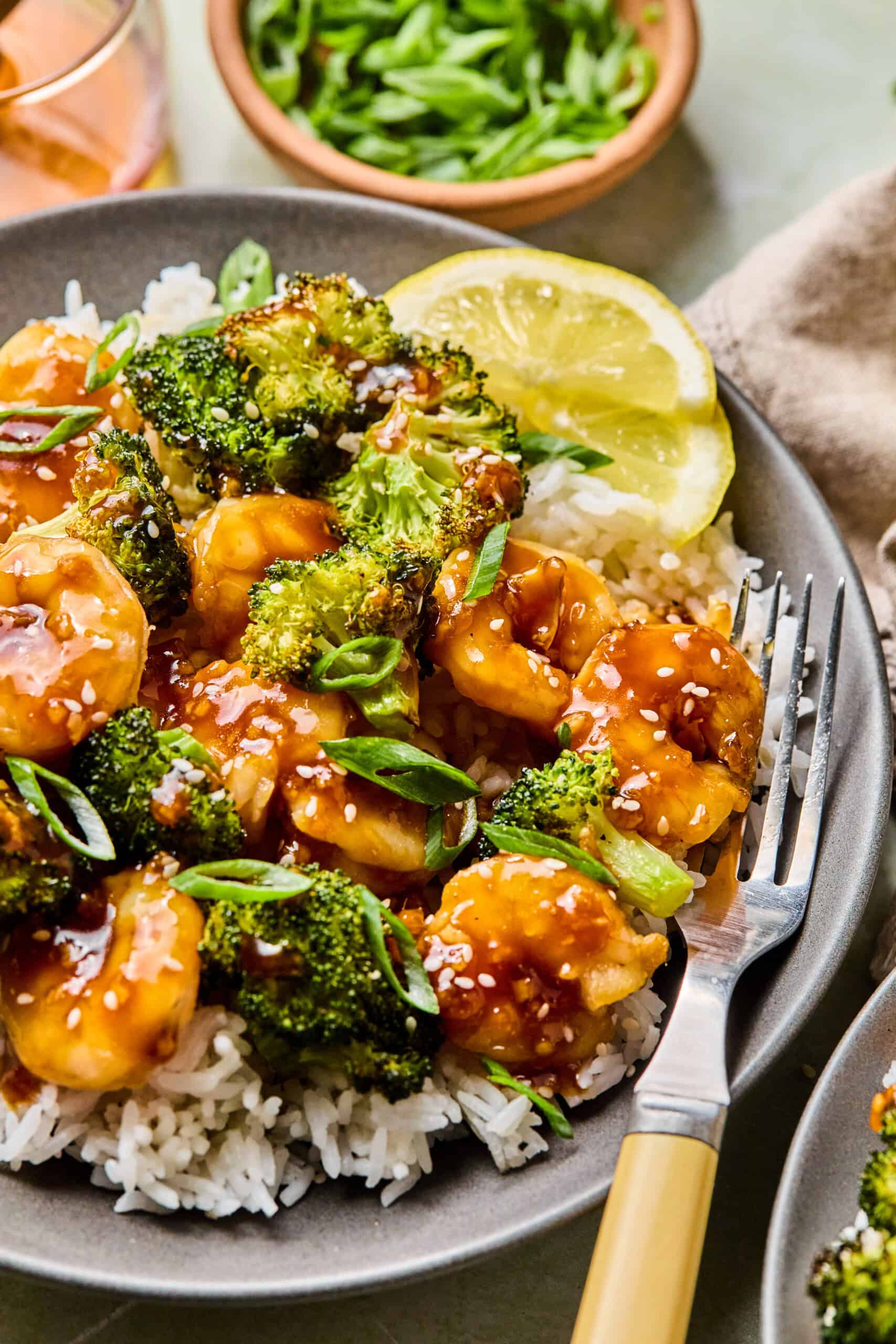 honey garlic shrimp, broccoli, and rice in a bowl with a fork.