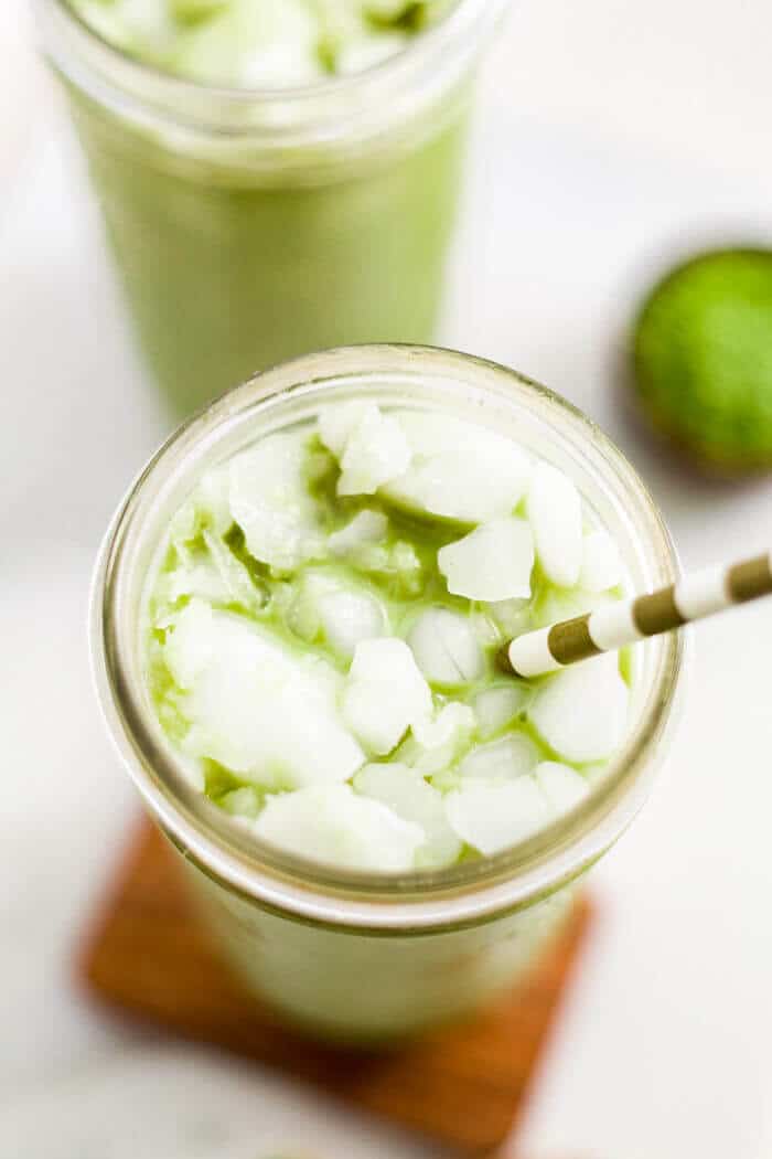 close up of an iced matcha latte recipe with a straw