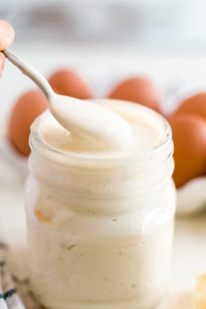 paleo mayo in a jar with a spoon scooping some out
