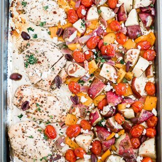 greek chicken with mixed veggies on a sheet pan
