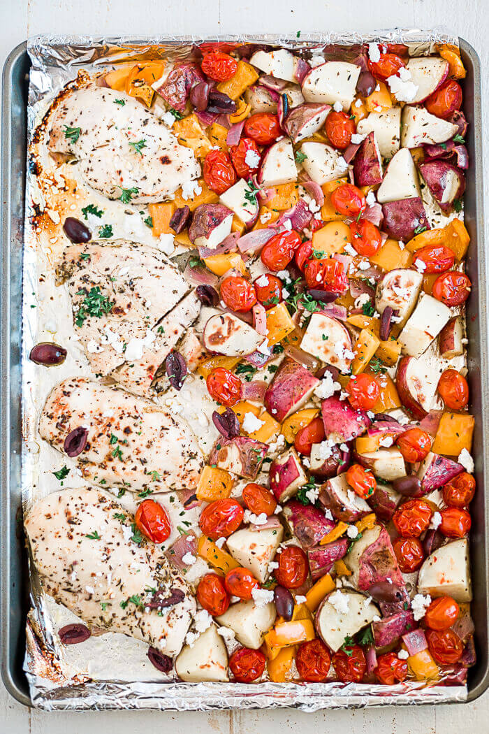 greek chicken with mixed veggies on a sheet pan