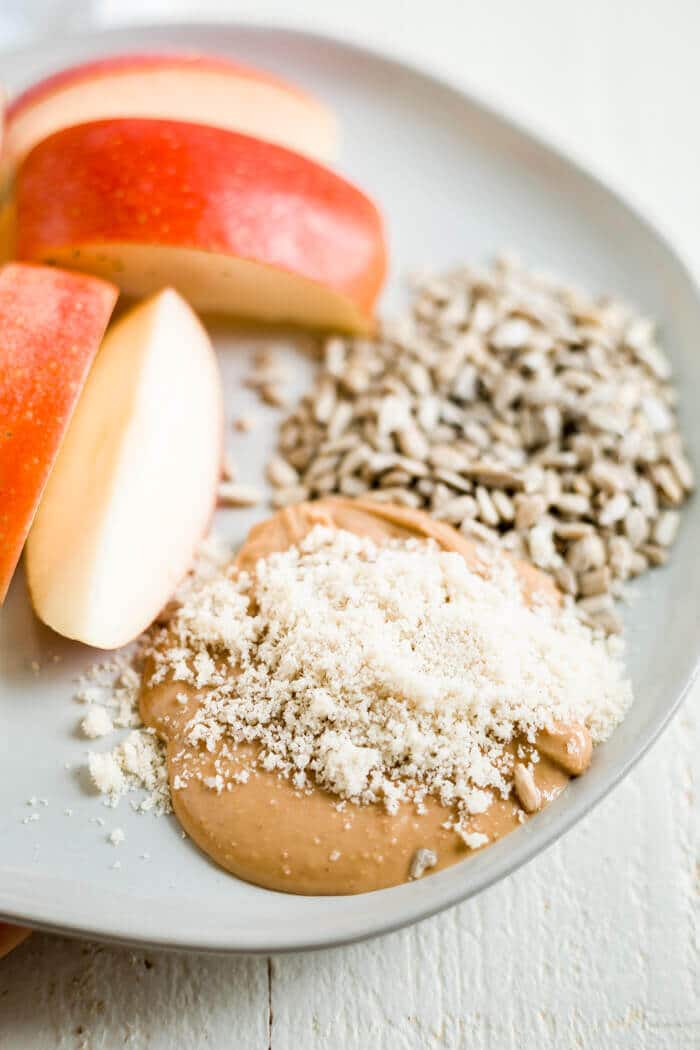 apple with cashew butter, ground sesame seeds and sunflower seeds to eat for seed cycling recipe