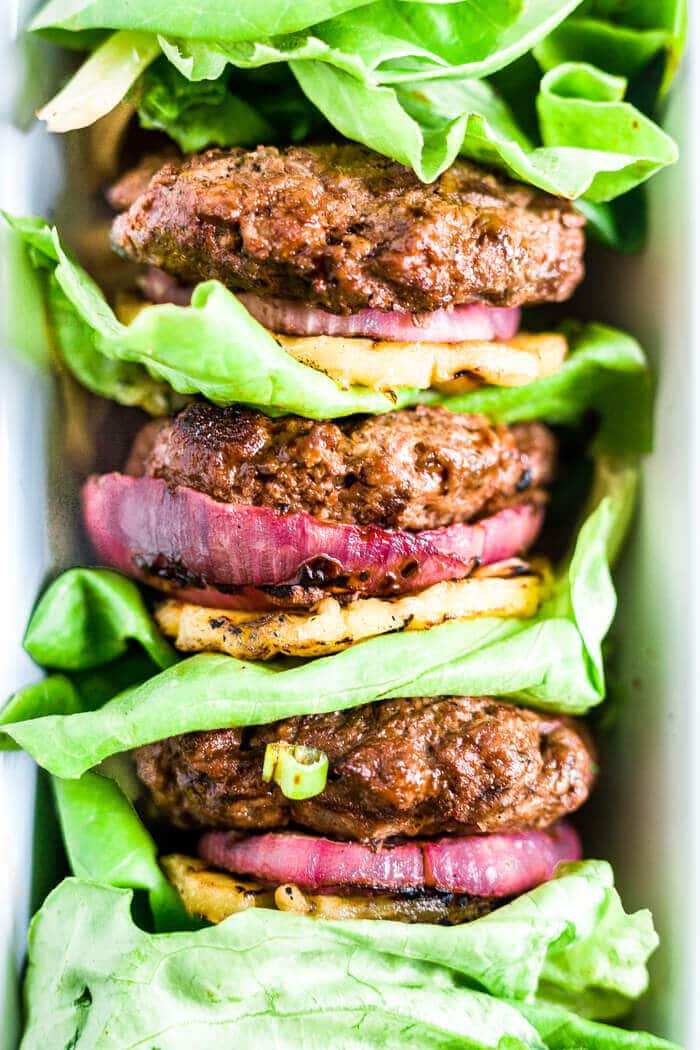 three hawaiian burgers with pineapple stacked with lettuce