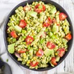 avocado pasta salad in a black bowl