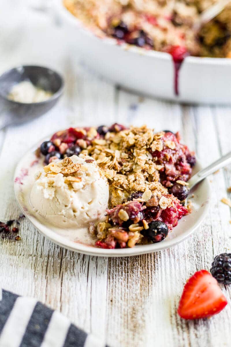 melting ice cream on a plate with a scoop of gluten free berry crisp oatmeal