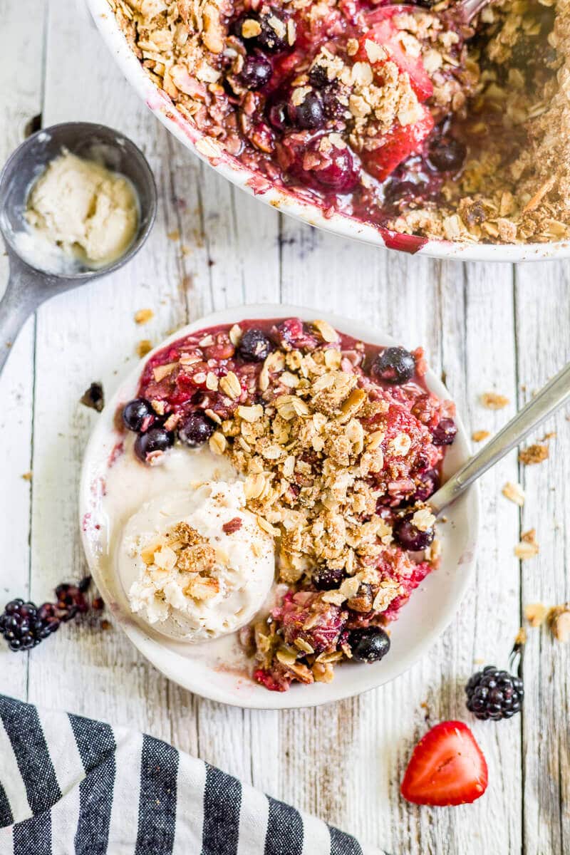 gluten free berry crisp on a plate with ice cream