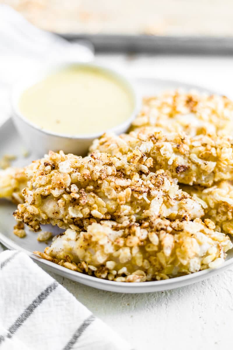 rice crispy chicken tenders on a plate with honey mustard