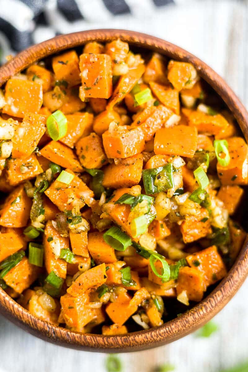 cold sweet potato salad close up so you can see the dressing and fresh herbs