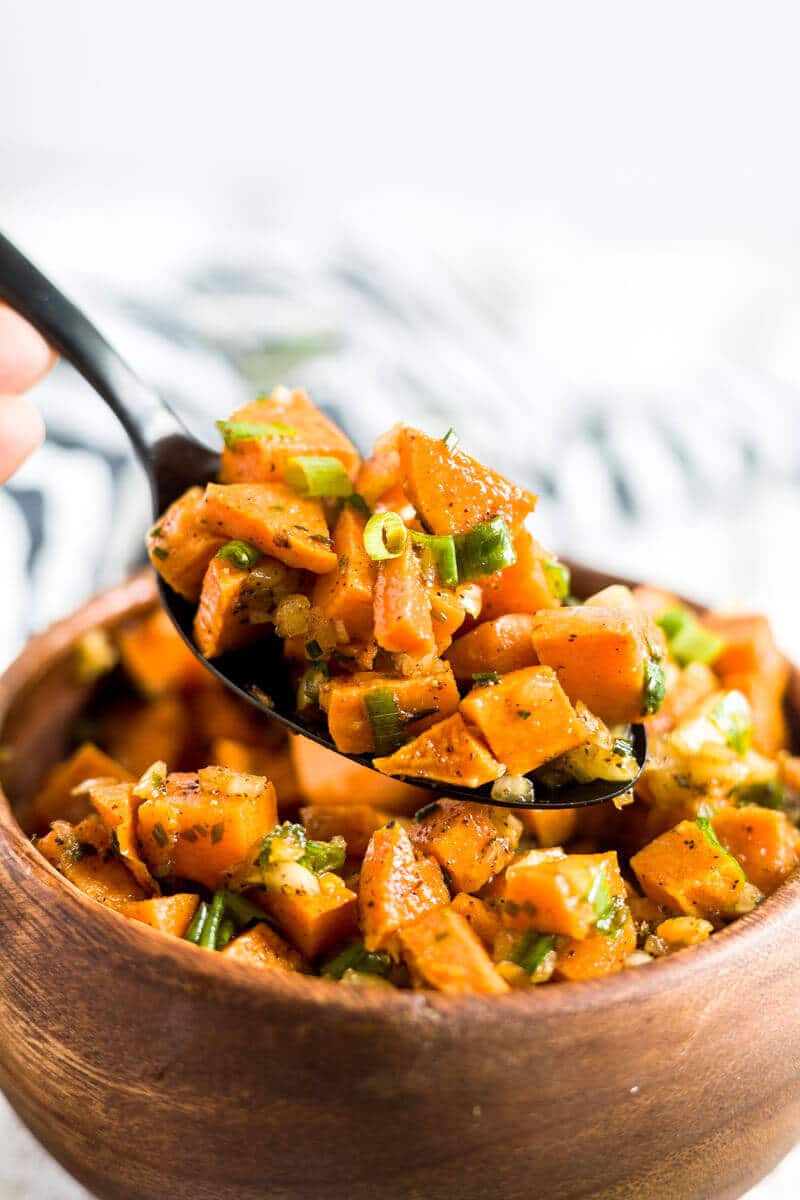 spoon scooping sweet potato salad out of a bowl