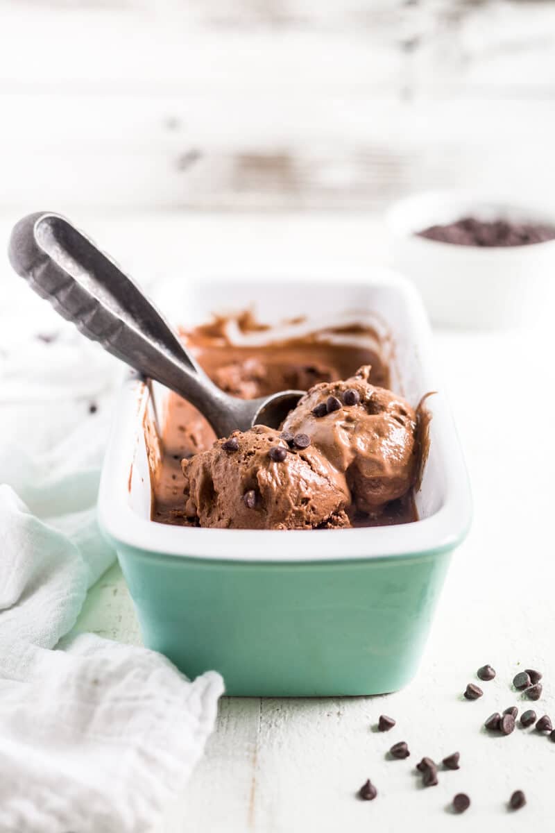 chocolate and banana ice cream in a pan with an ice cream scoop
