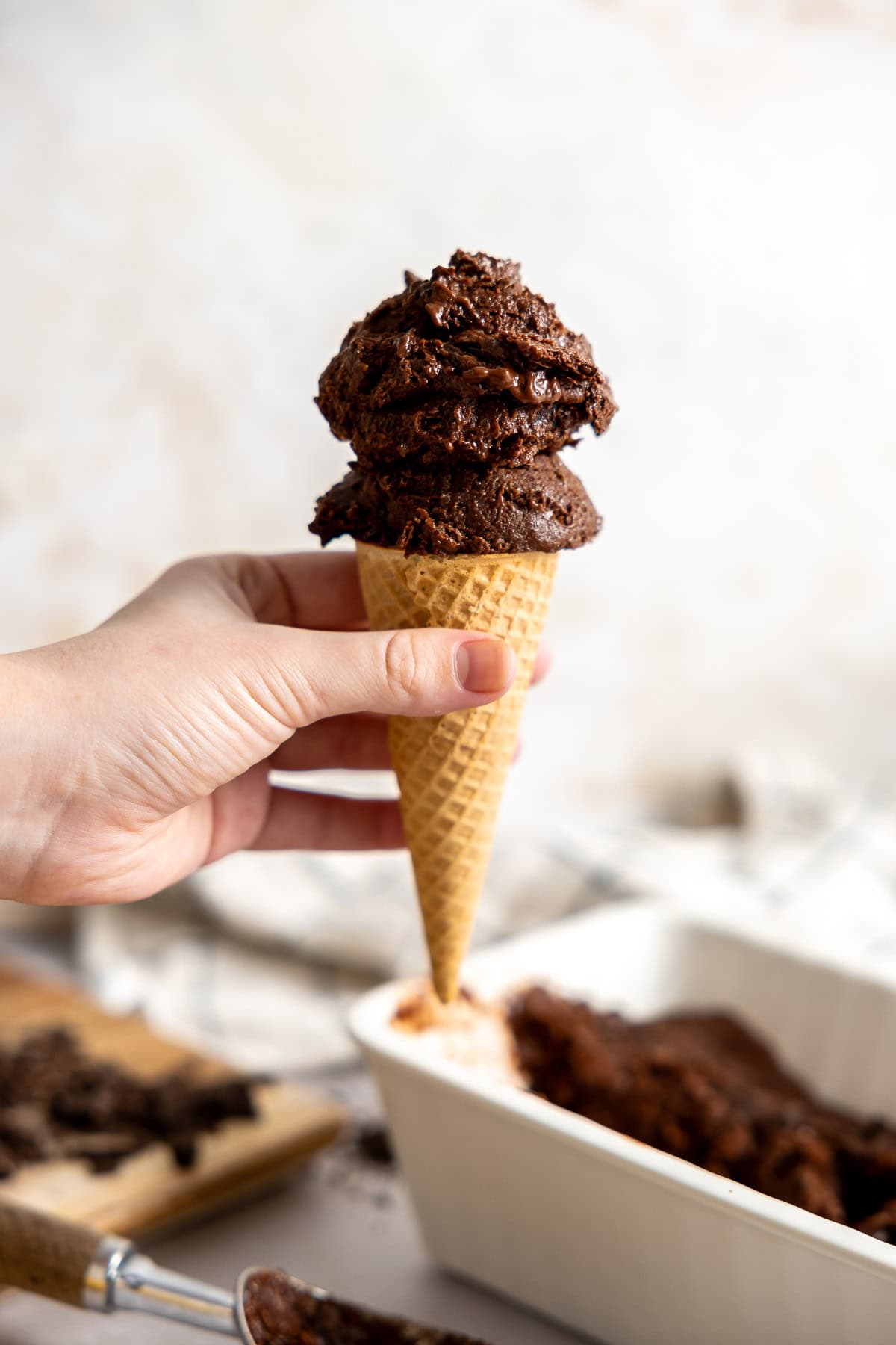 2 scoops of vegan chocolate banana ice cream on a cone.