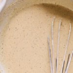 whisked orange cauliflower batter in a mixing bowl.