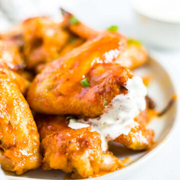 honey sriracha wings on a plate with ranch