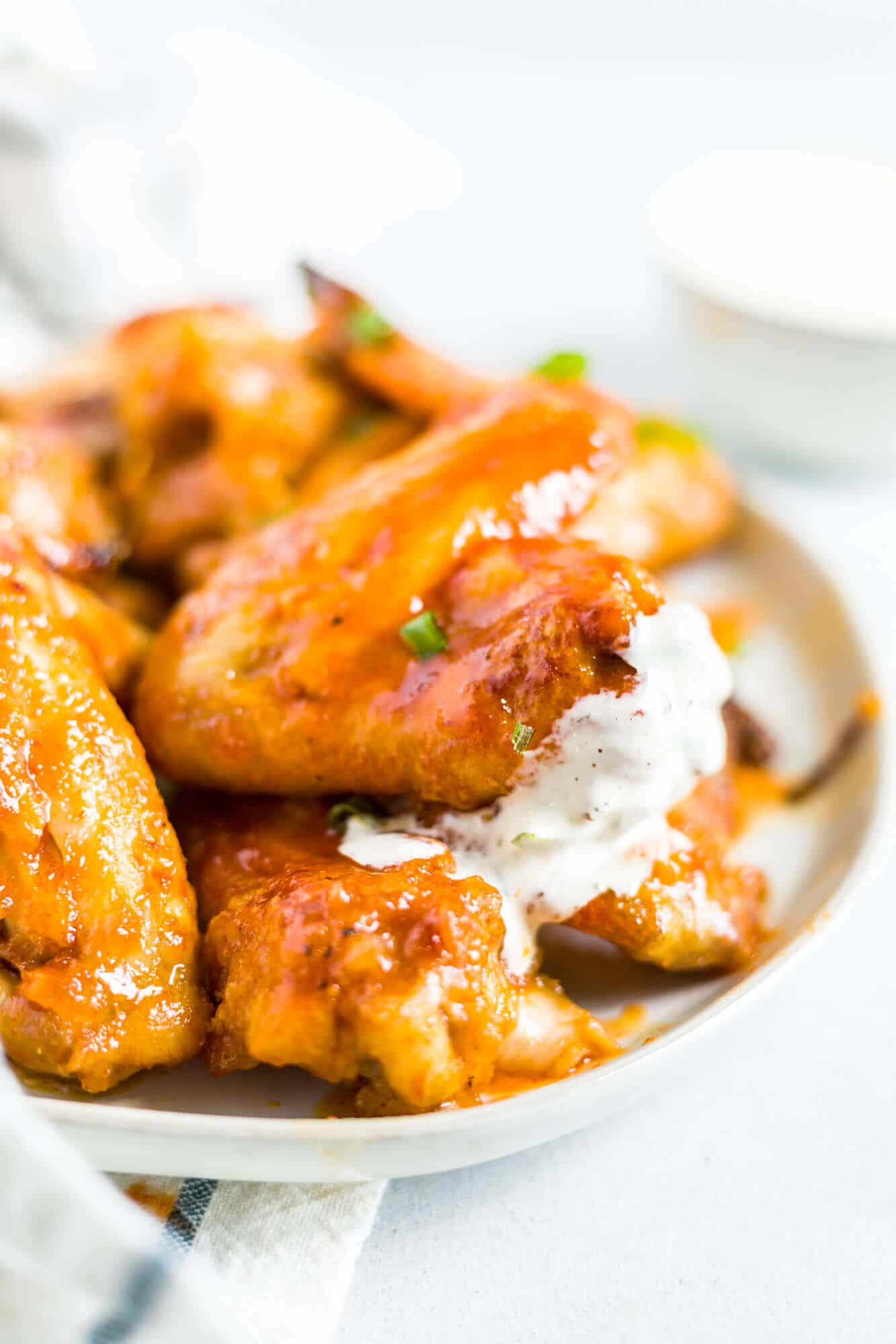 honey sriracha wings on a plate with ranch