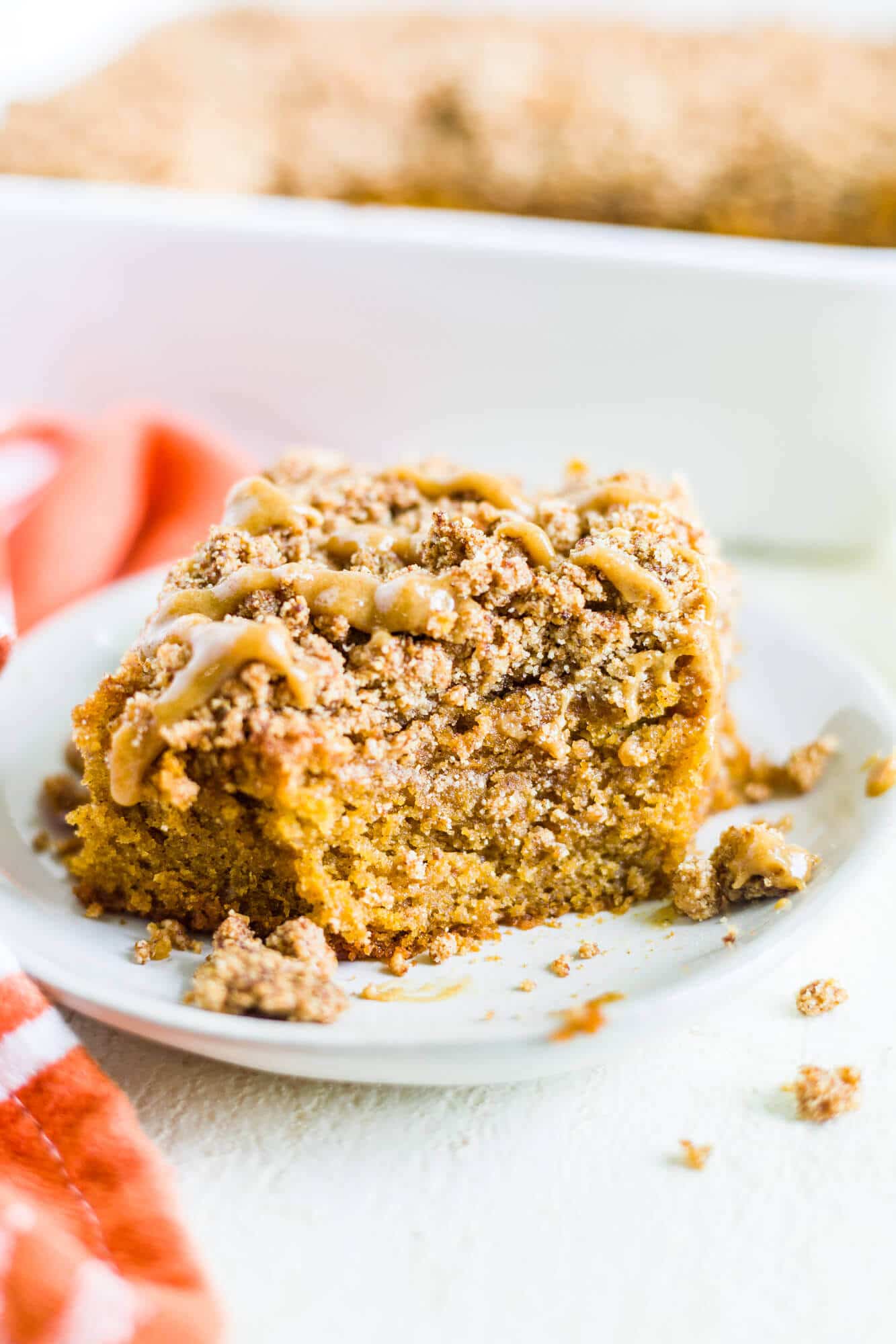 pumpkin coffee cake on a plate with a bite taken out