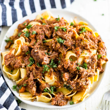 beef ragu with pappardelle on a plate with a fork