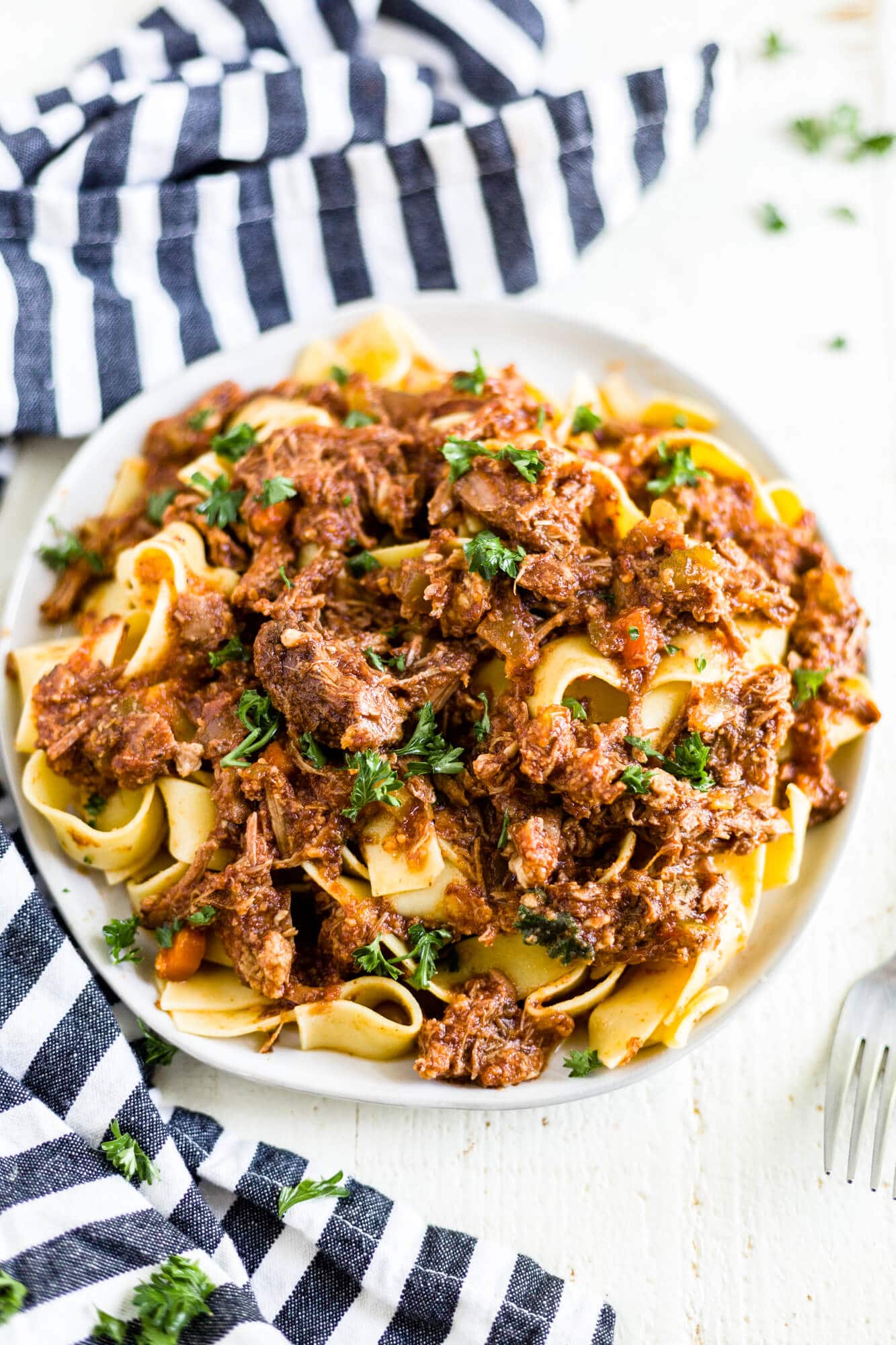 beef ragu with pappardelle on a plate with a fork