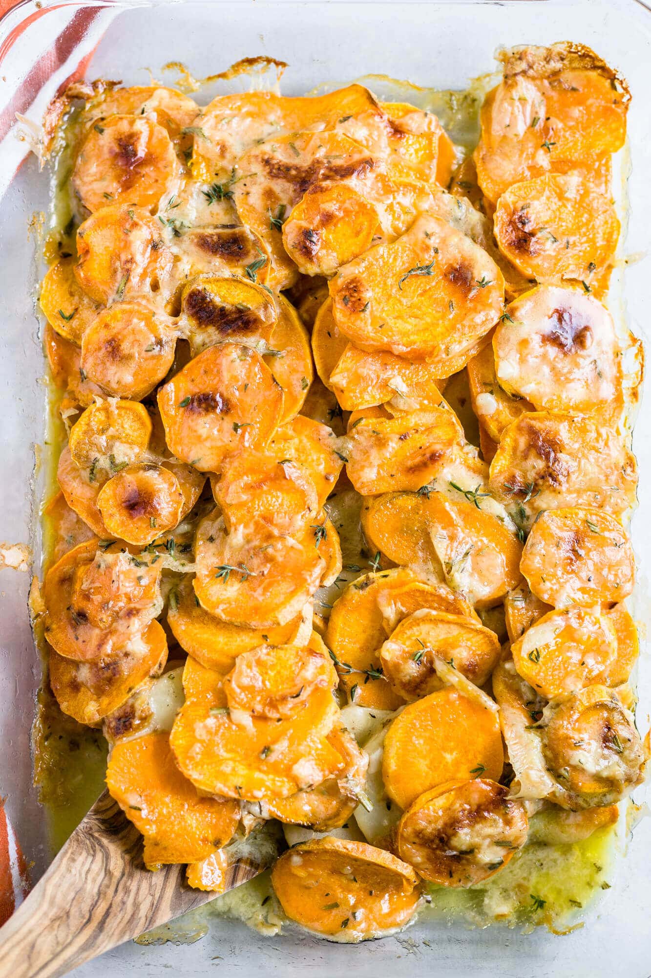 scalloped sweet potato in a glass baking dish to serve