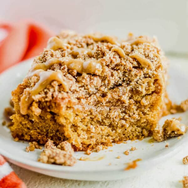 a piece of healthy pumpkin coffee cake on a plate with a bite taken out.