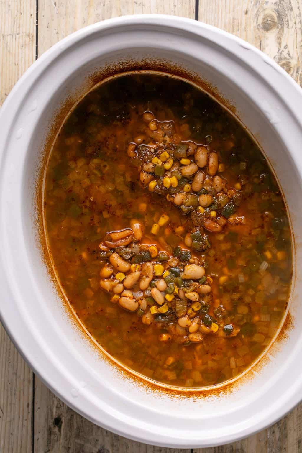 slow cooker white chicken chili right after slow cooking before the chicken is shredded.